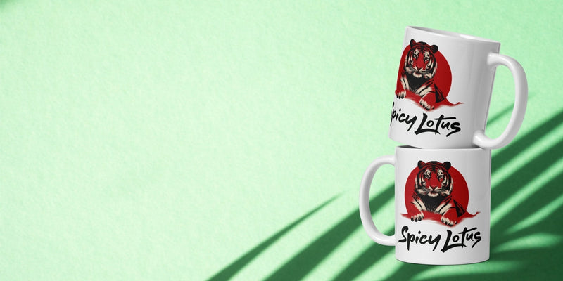 Green tropical background with soft leaf shadows and two white ceramic mugs with bold tiger design