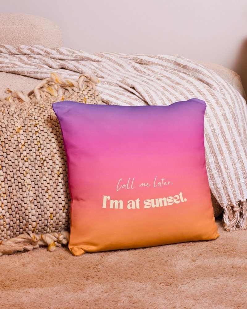 Gradient pillow with printed text on a bright sofa.