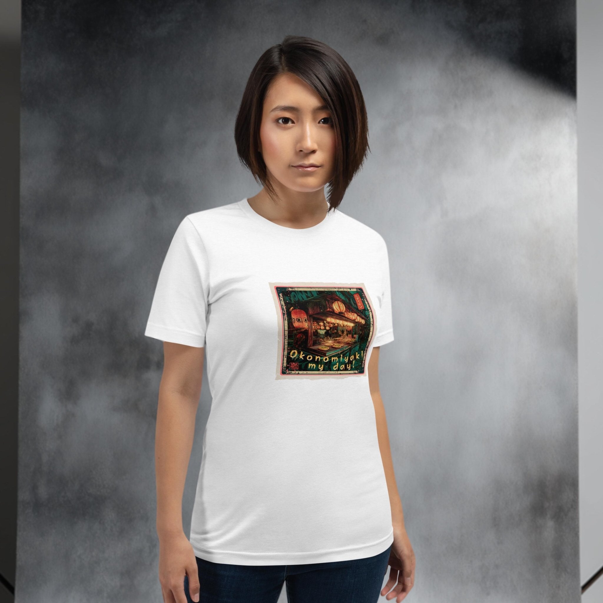 Person wearing a white t-shirt with a graphic design of an okonomiyaki stall in Japan on a gray background