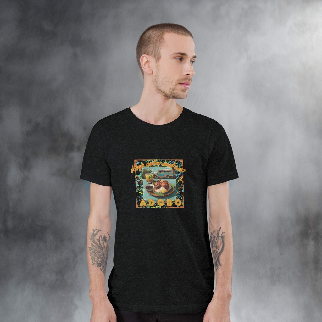 Man wearing a black t-shirt with a colorful graphic design of Adobo against a gray background