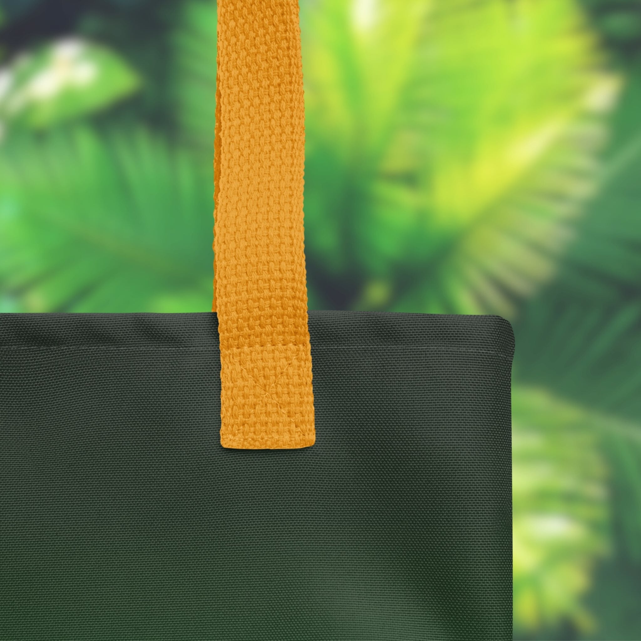 Black bag with a yellow strap against a green leafy background
