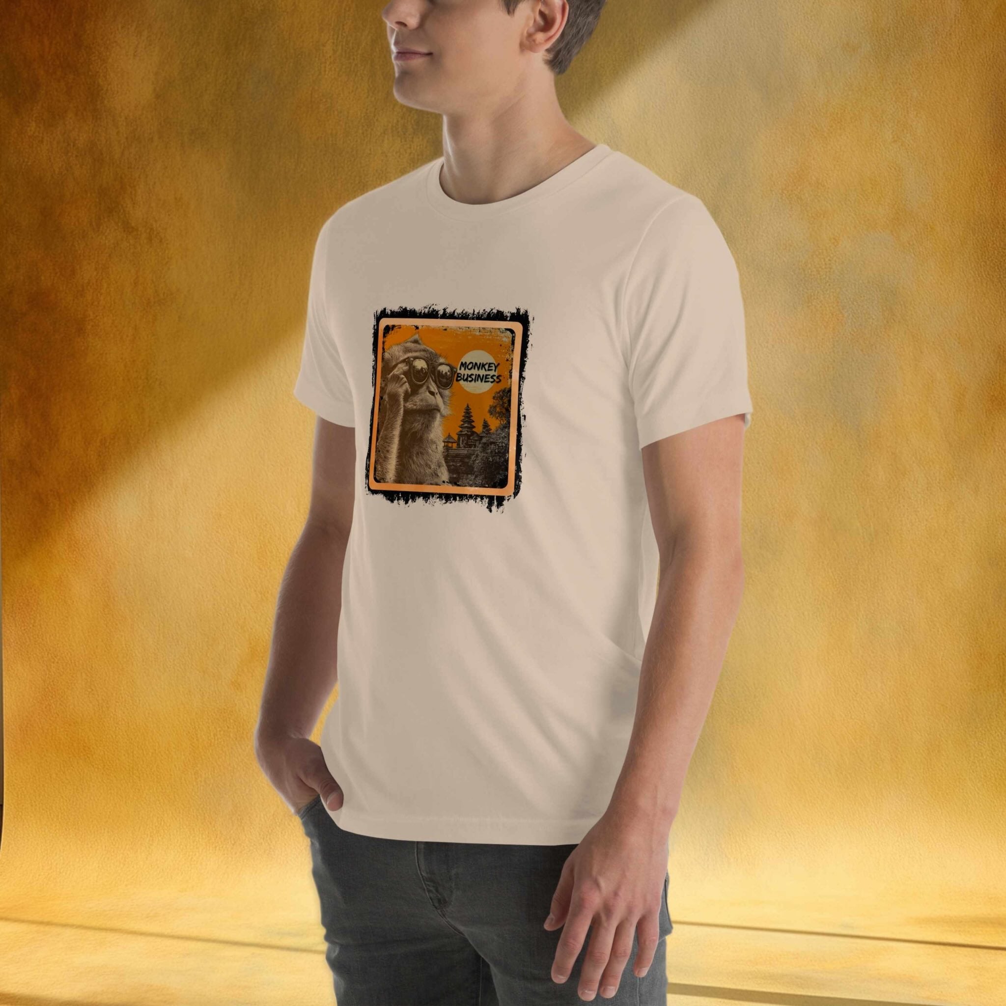 Person wearing a beige t-shirt with a graphic design of a monkey on a warm gradient background