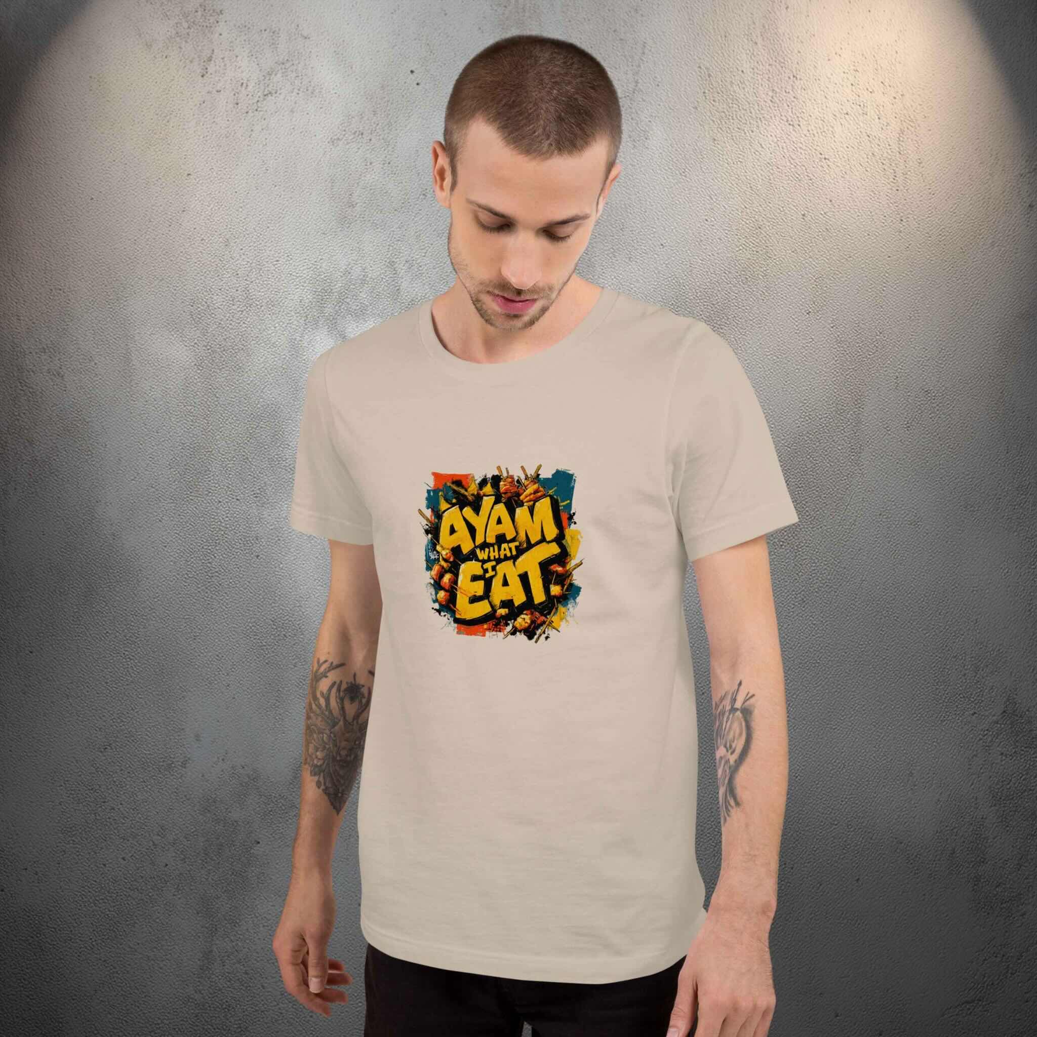 Man wearing a beige t-shirt with a colorful graffiti design on a gray background