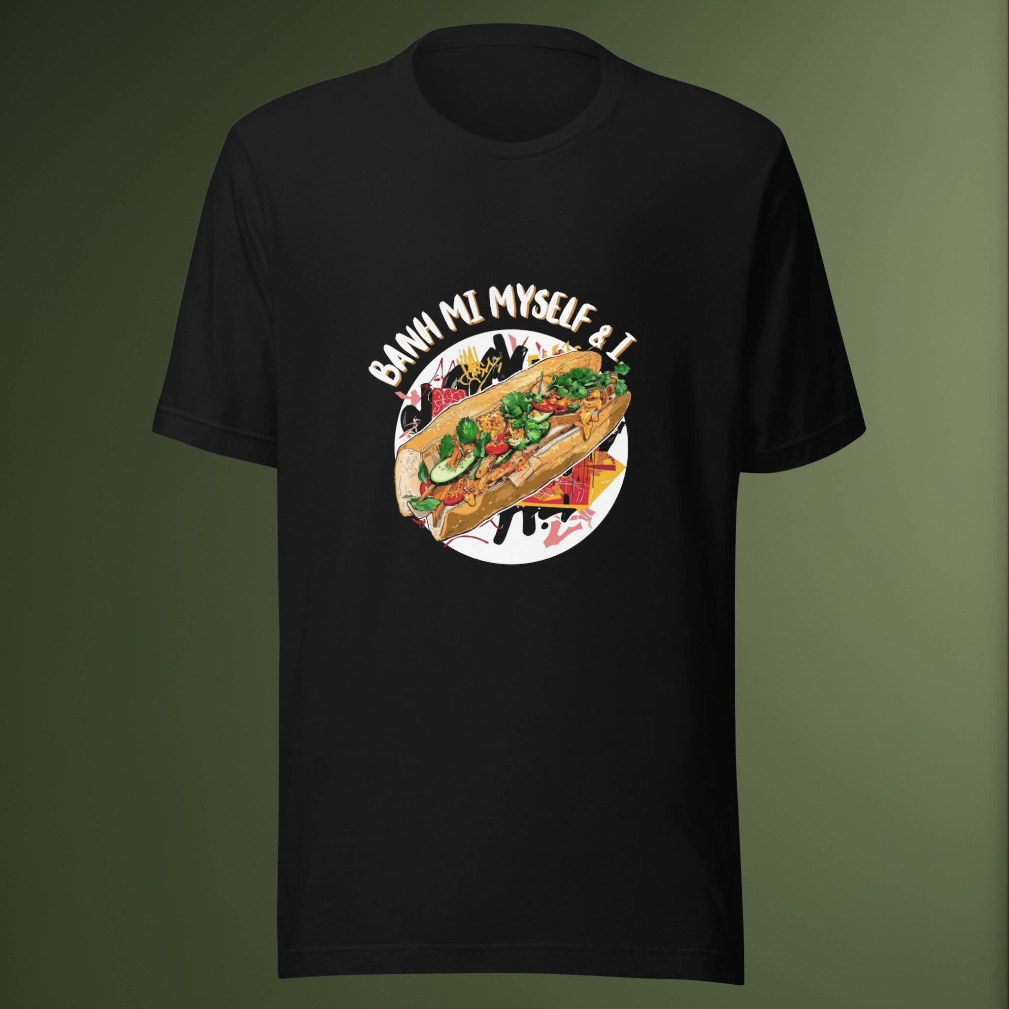 Black t-shirt with a colorful graphic of a banh mi sandwich and text on a green background