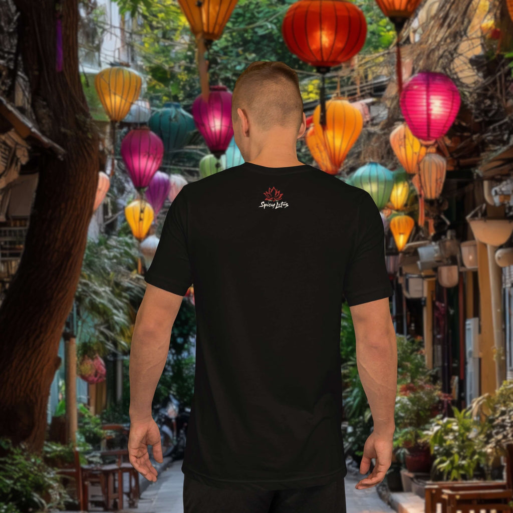 Man wearing a black t-shirt with a logo in an outdoor setting with colorful lanterns.