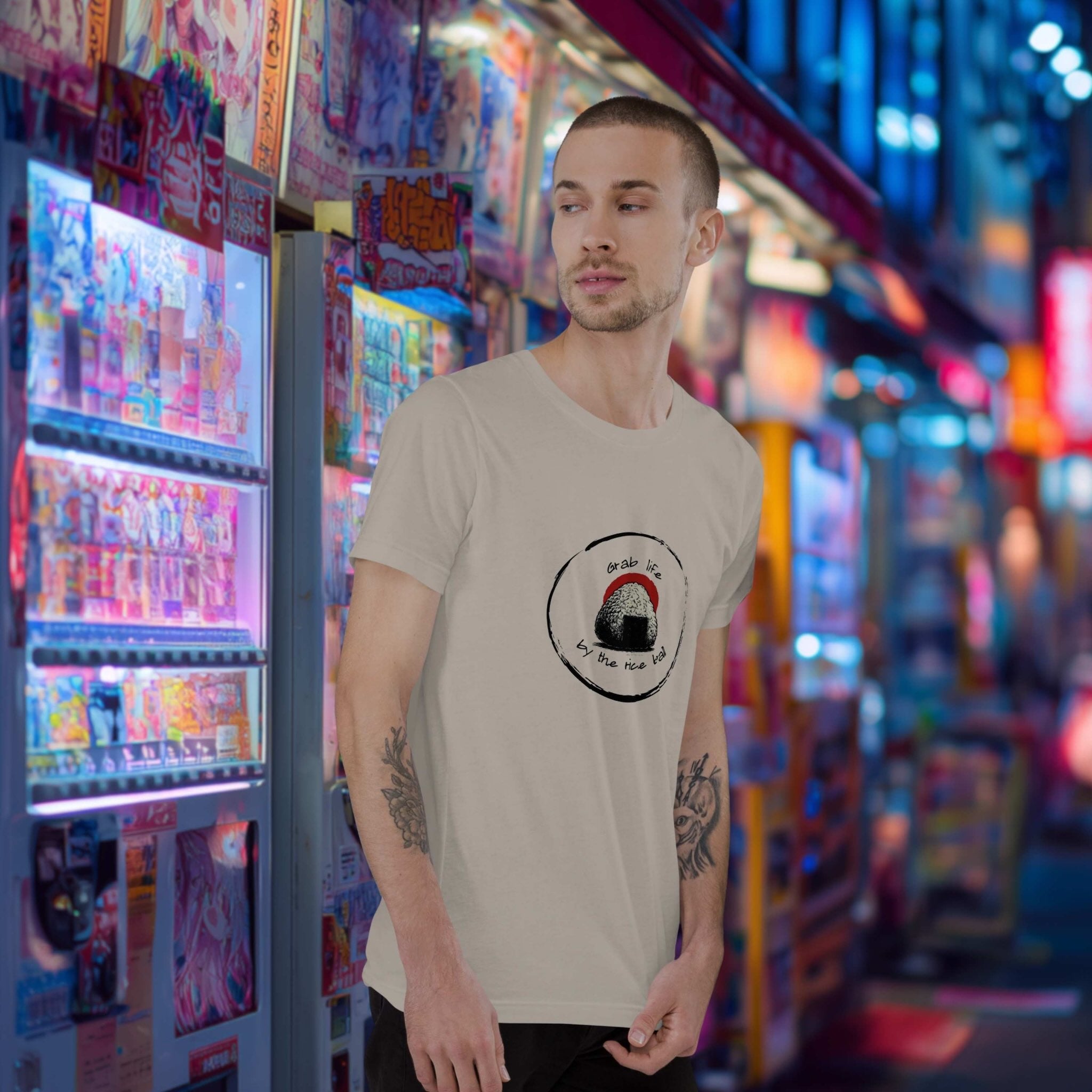 Man standing in front of a colorful vending machine display wearing Grab Life by the Rice Ball onigiri front print t-shirt