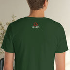 Person wearing a green t-shirt with a logo on the back, standing against a neutral background.