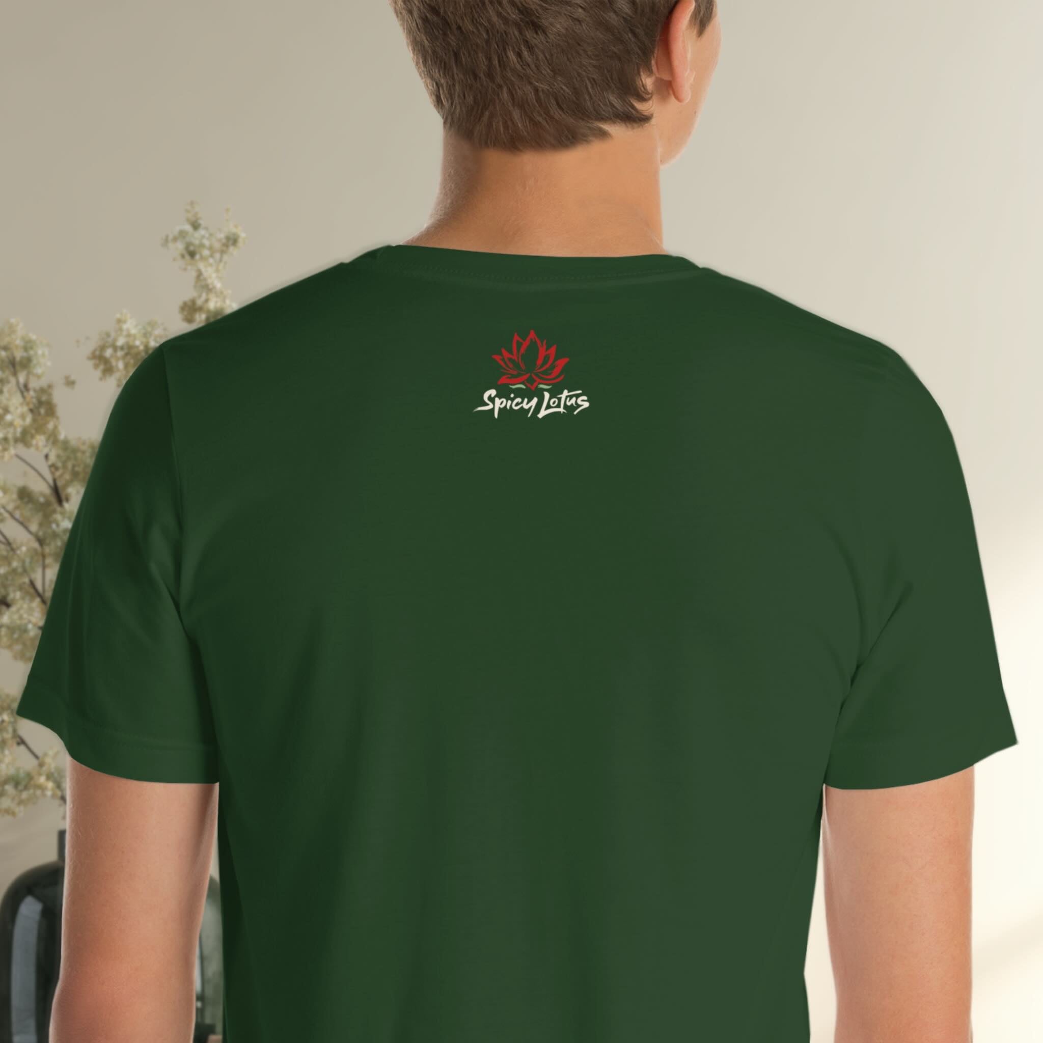 Person wearing a green t-shirt with a logo on the back, standing against a neutral background.