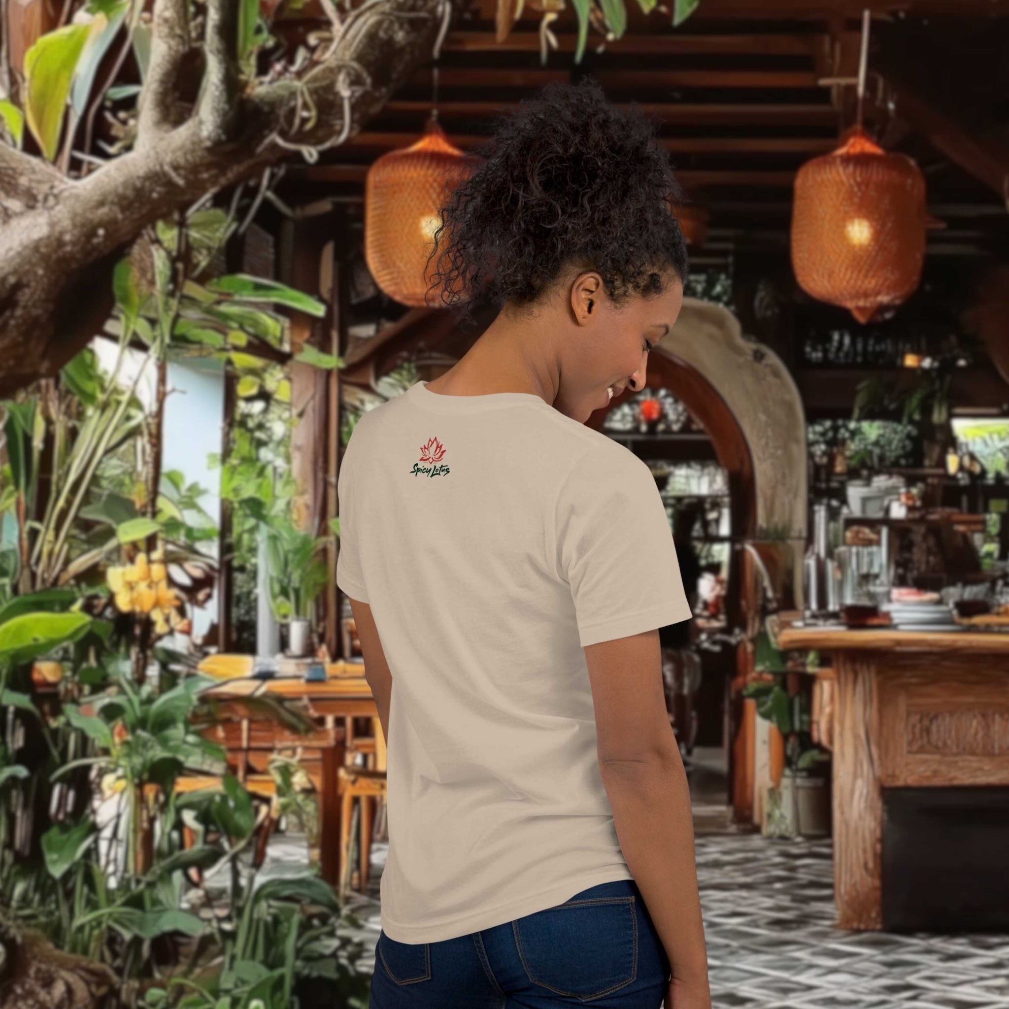 Person wearing a white t-shirt with a logo in a tropical-themed restaurant.