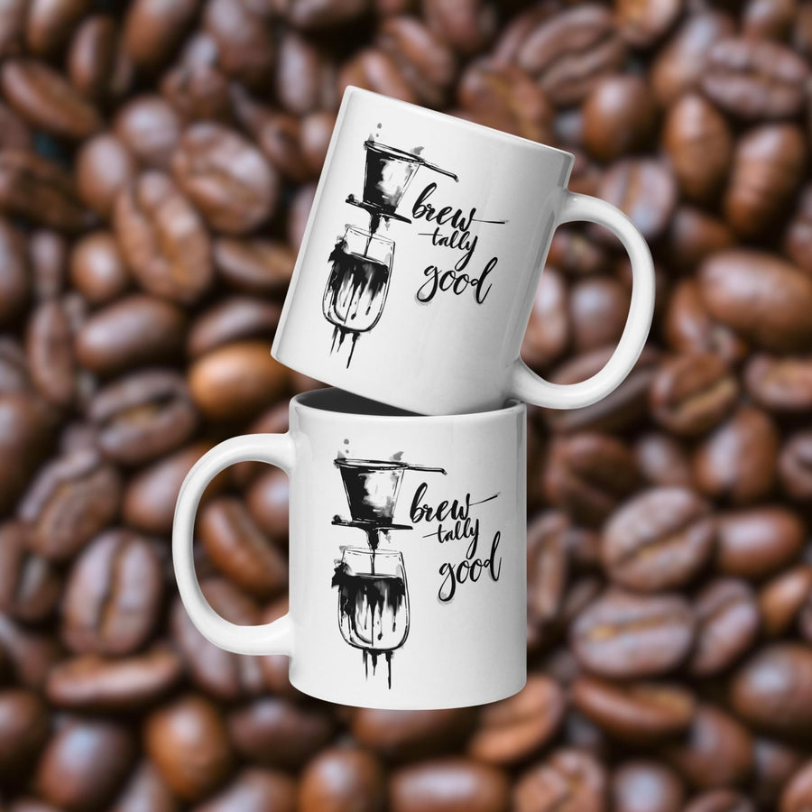 Two white 20 oz ceramic coffee mugs with brewtally Good Vietnamese phin coffee graphic with coffee beans in the background