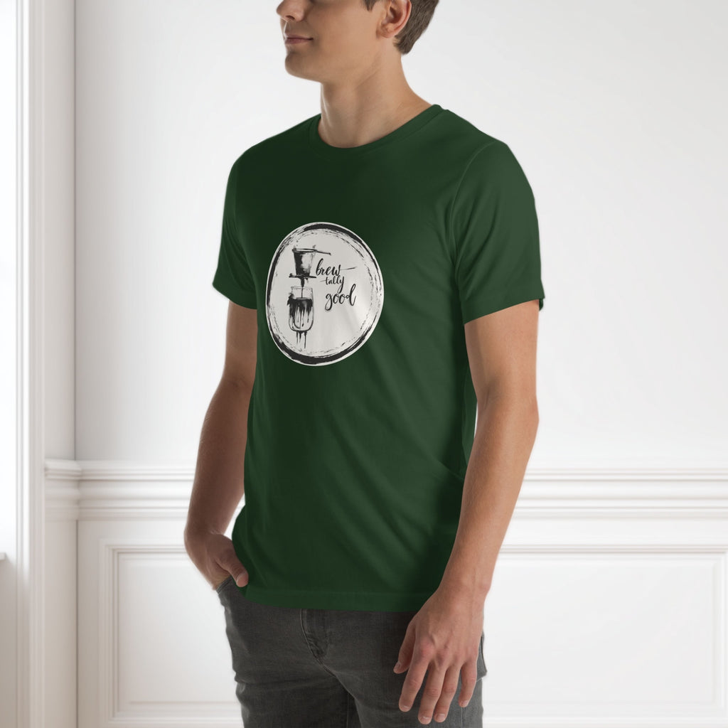 Person wearing a green t-shirt with a graphic design of vietnamese coffee on a white wall background