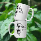 Two white 15 oz mugs with coffee-themed designs and 'brewtally good' text on a green leafy background.