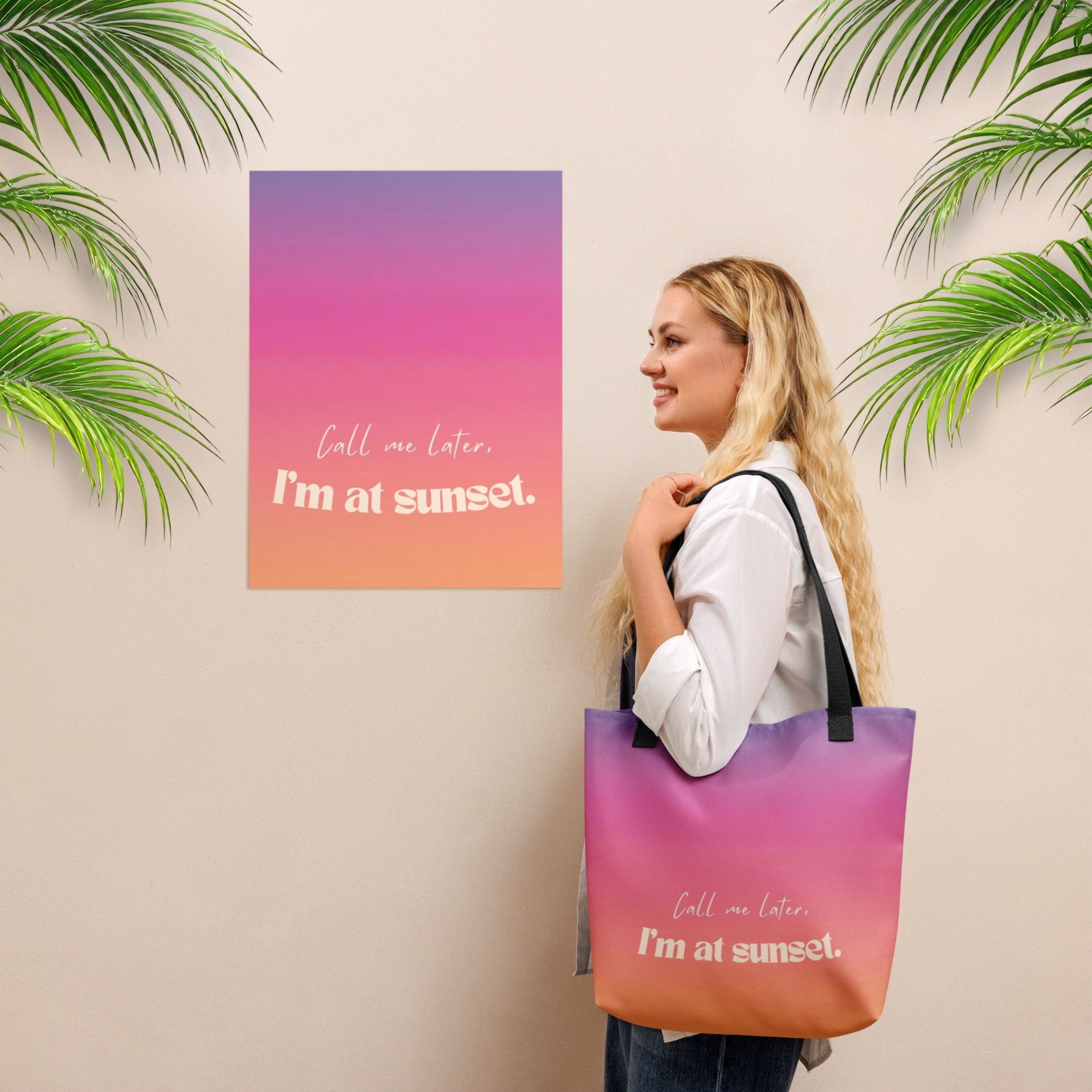 Woman holding a gradient tote bag with 'Call me later, I'm at sunset' text, wall art in the background.