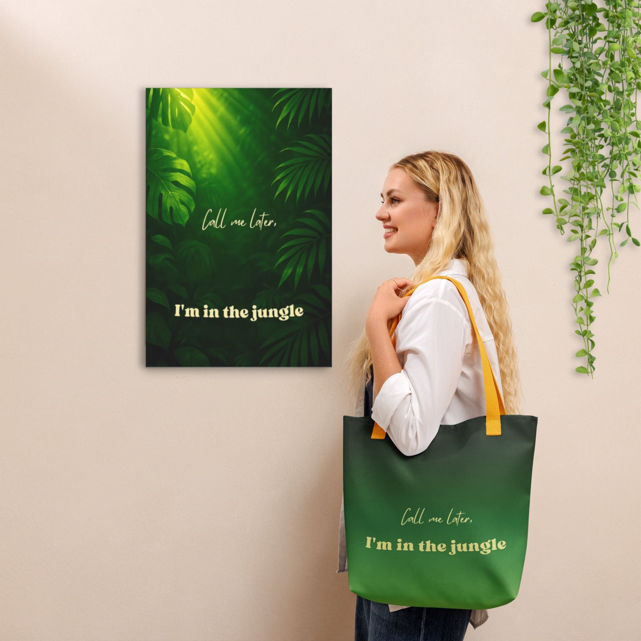 Woman holding a green tote bag with text next to a matching wall art piece.