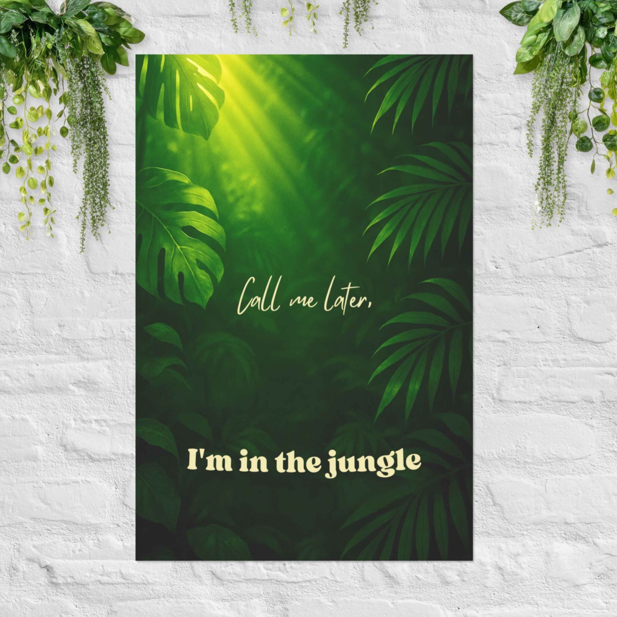 Poster with tropical leaves and Call Me Later, I’m in the Jungle poster with green foliage on white wall