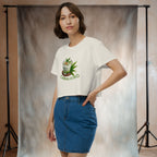 Woman wearing a white t-shirt with a graphic design of indonesian dessert cendol and a blue denim skirt, standing against a neutral backdrop.