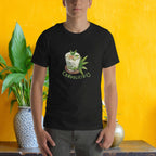Person wearing a black t-shirt with a graphic design of Cendol dessert against a yellow background