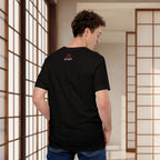 Person wearing a black t-shirt with a logo, standing in a room with wooden sliding doors.