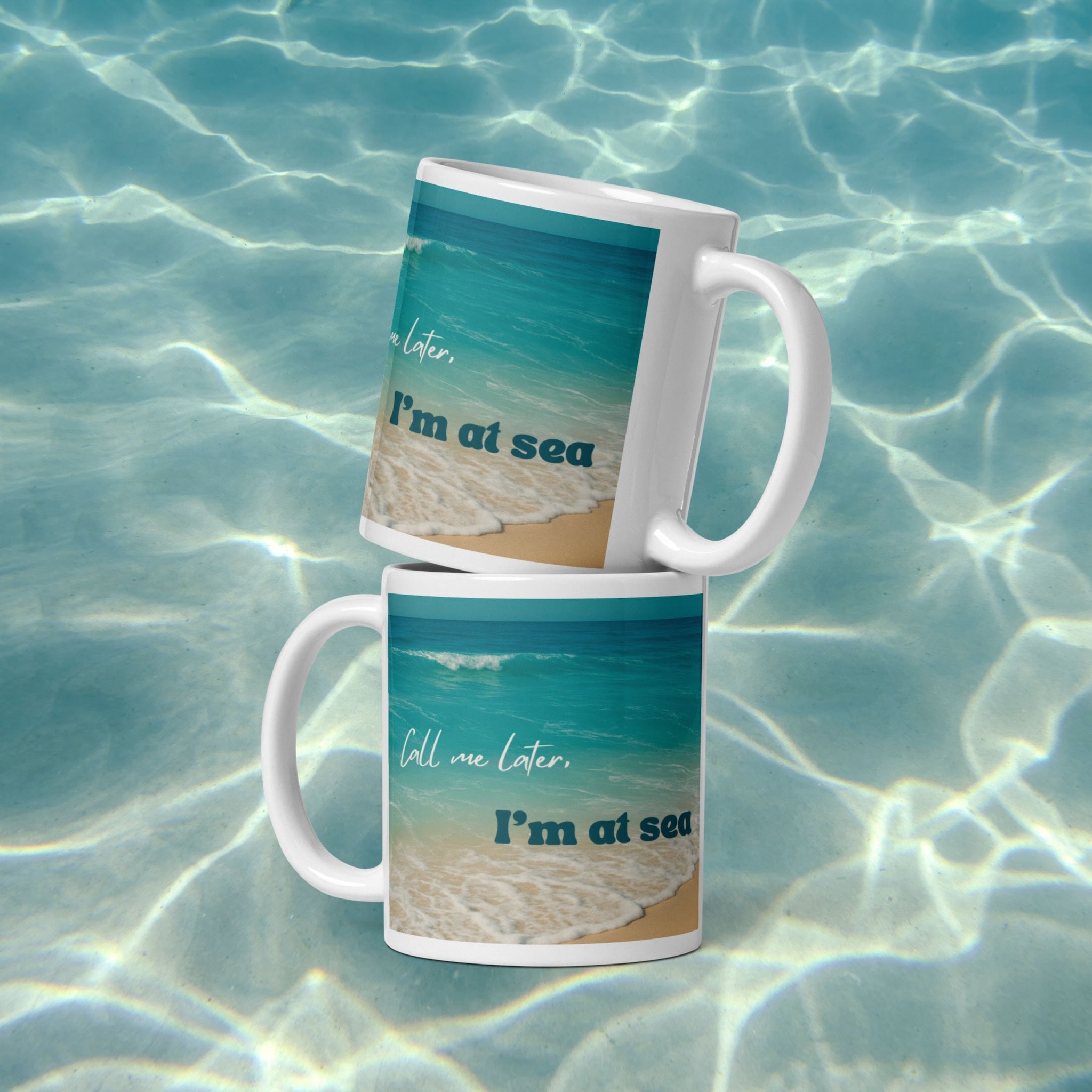 Two mugs with beach-themed design on a water background