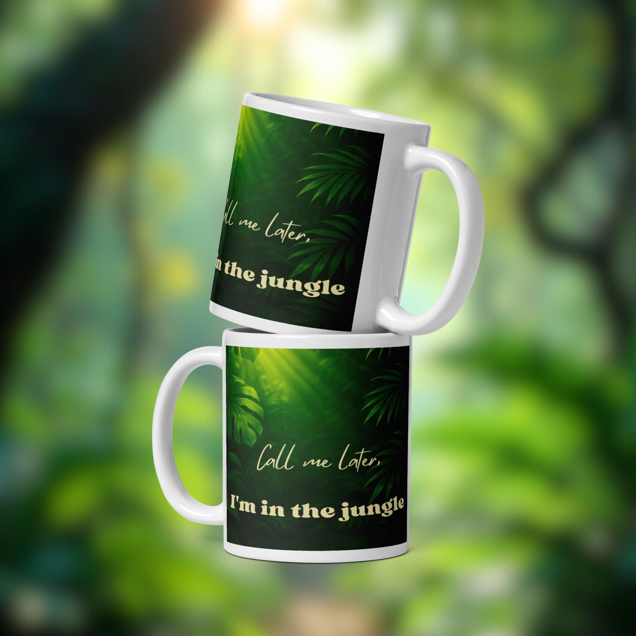 Two mugs with jungle-themed design and text on a blurred green background
