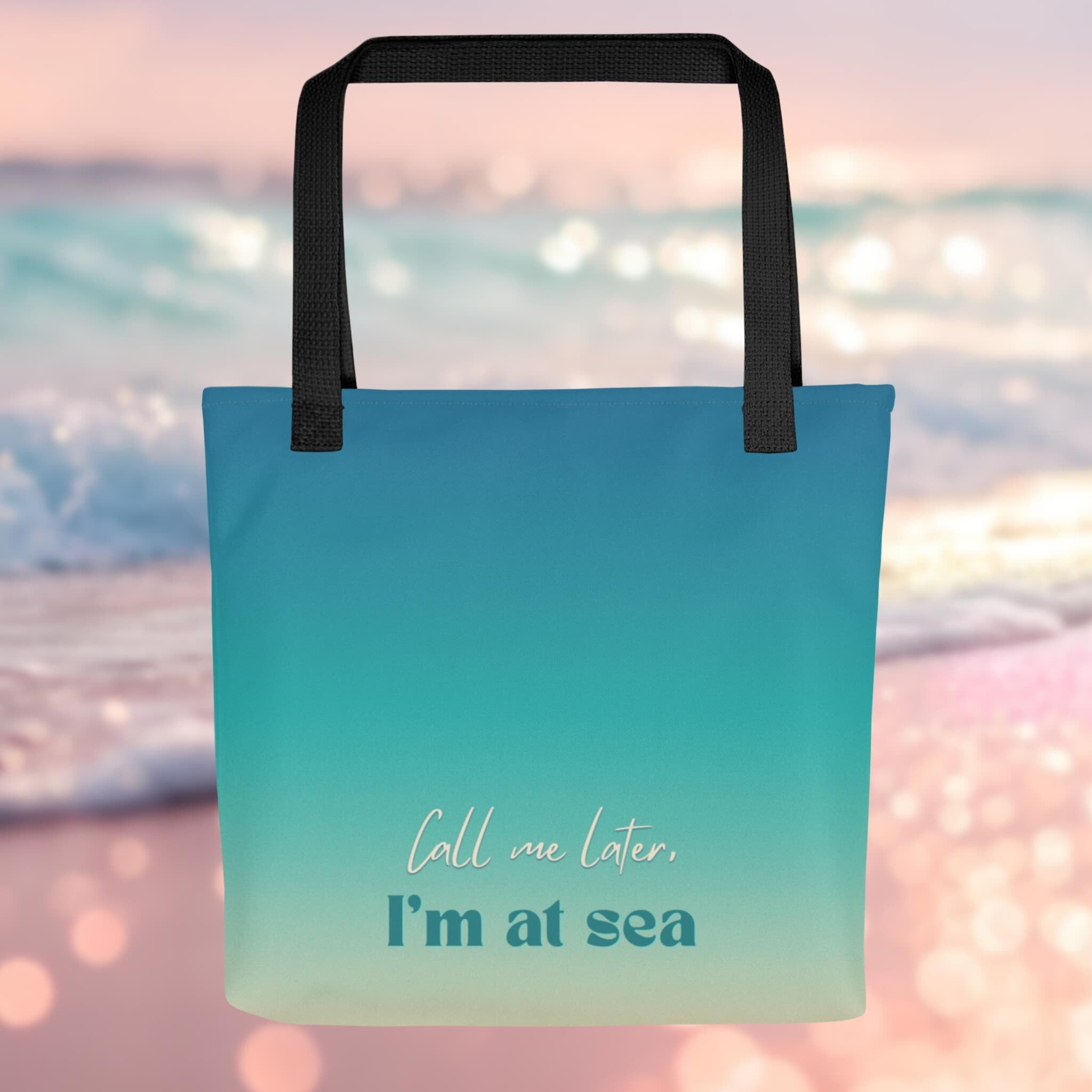 Tote bag with 'Call me later, I'm at sea' text on a beach background