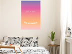 Poster with 'Call me later, I'm at sunset' text on a wall above a bed.