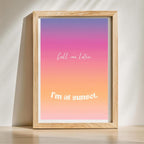 Framed print with gradient background and text 'Call me later. I'm at sunset.' on a light surface.