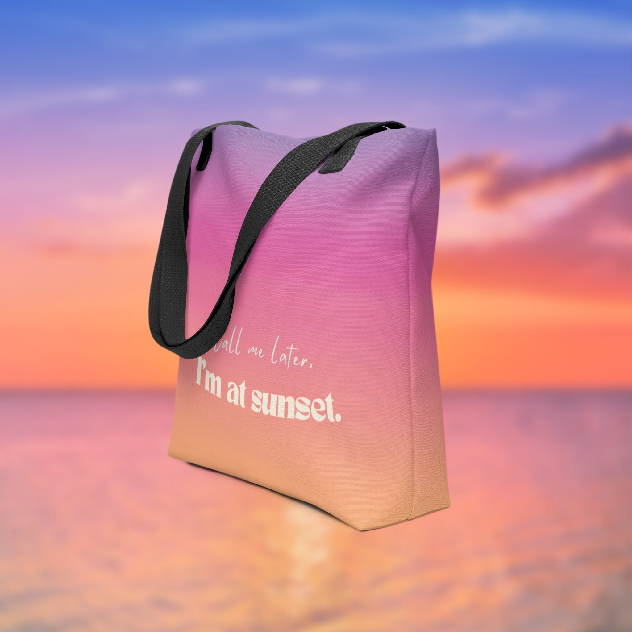Tote bag with 'Call me later, I'm at sunset' text against a colorful sky background