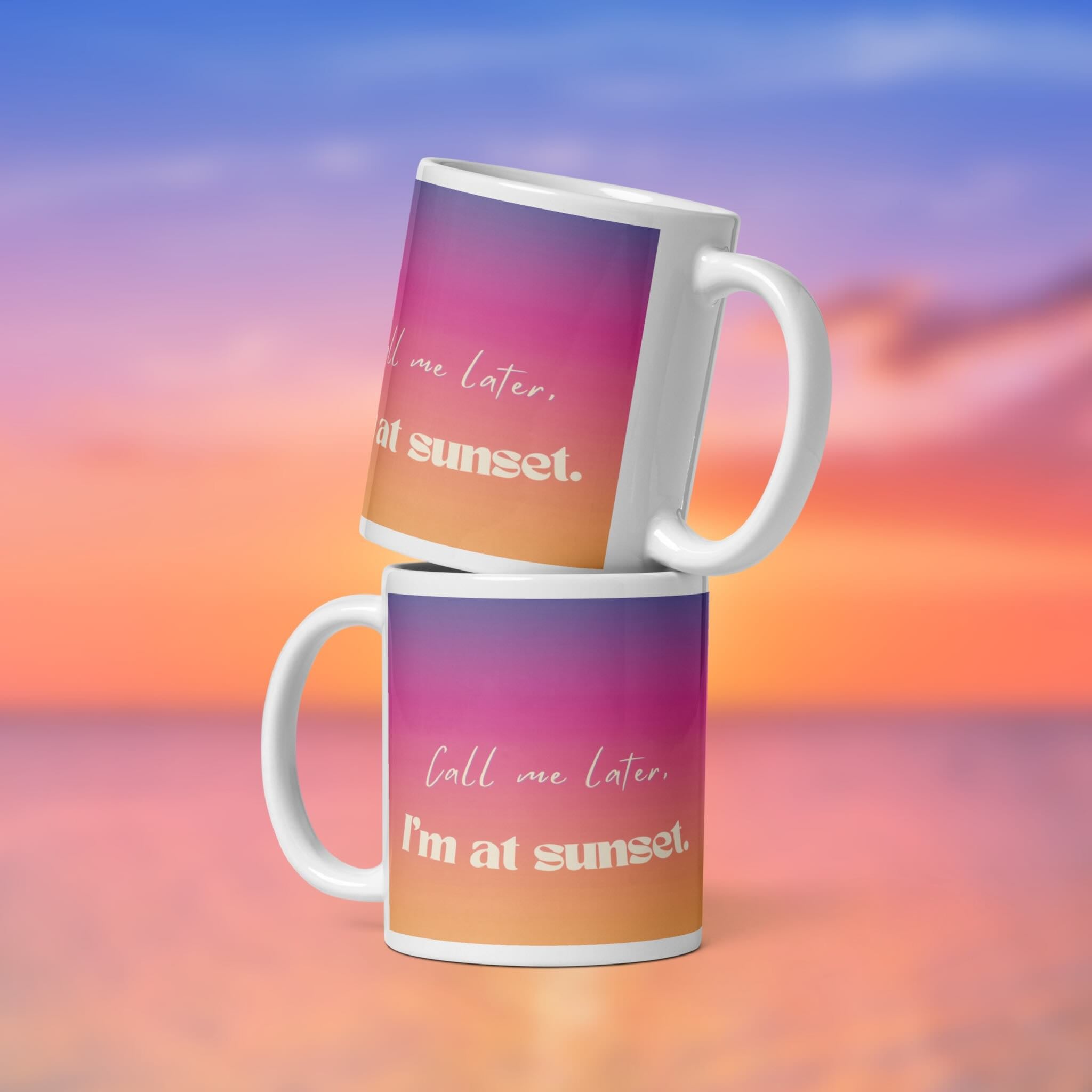 Two mugs with sunset-themed text against a colorful sky background