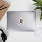Laptop with a 'Spicy Lotus' sticker with a colorful gecko graphic on a laptop on white surface with office items.