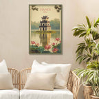 Framed artwork of Hanoi with a traditional tower and lotus flowers on a wall above a sofa.