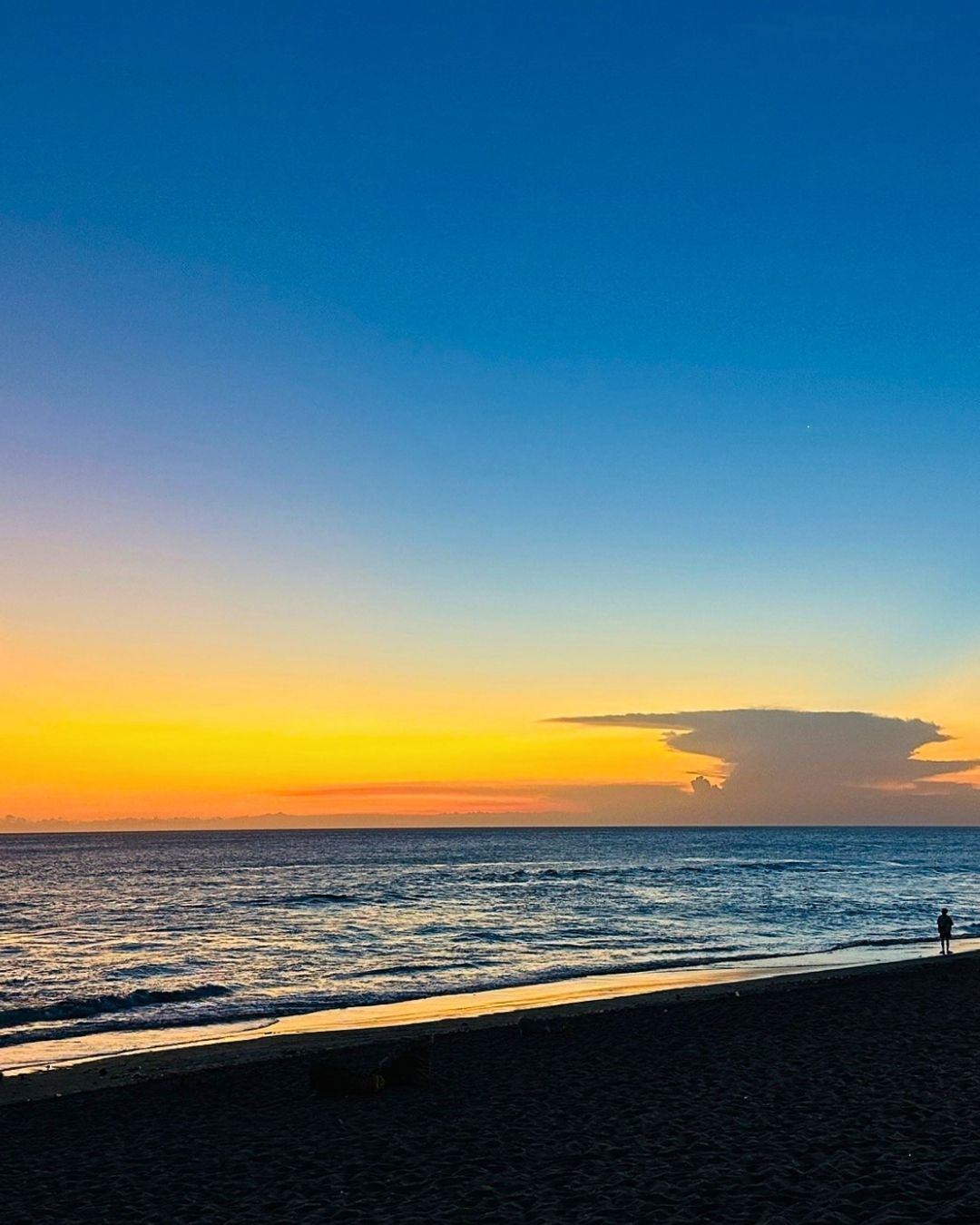 Sunset at bach in Bali with yellow-blue sky