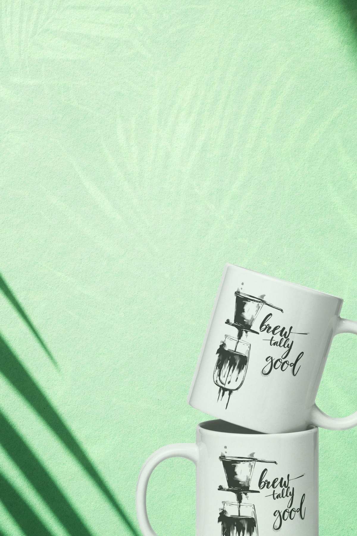 Two white coffee mugs with black text 'Brewtally good' and graphics on a light green background.