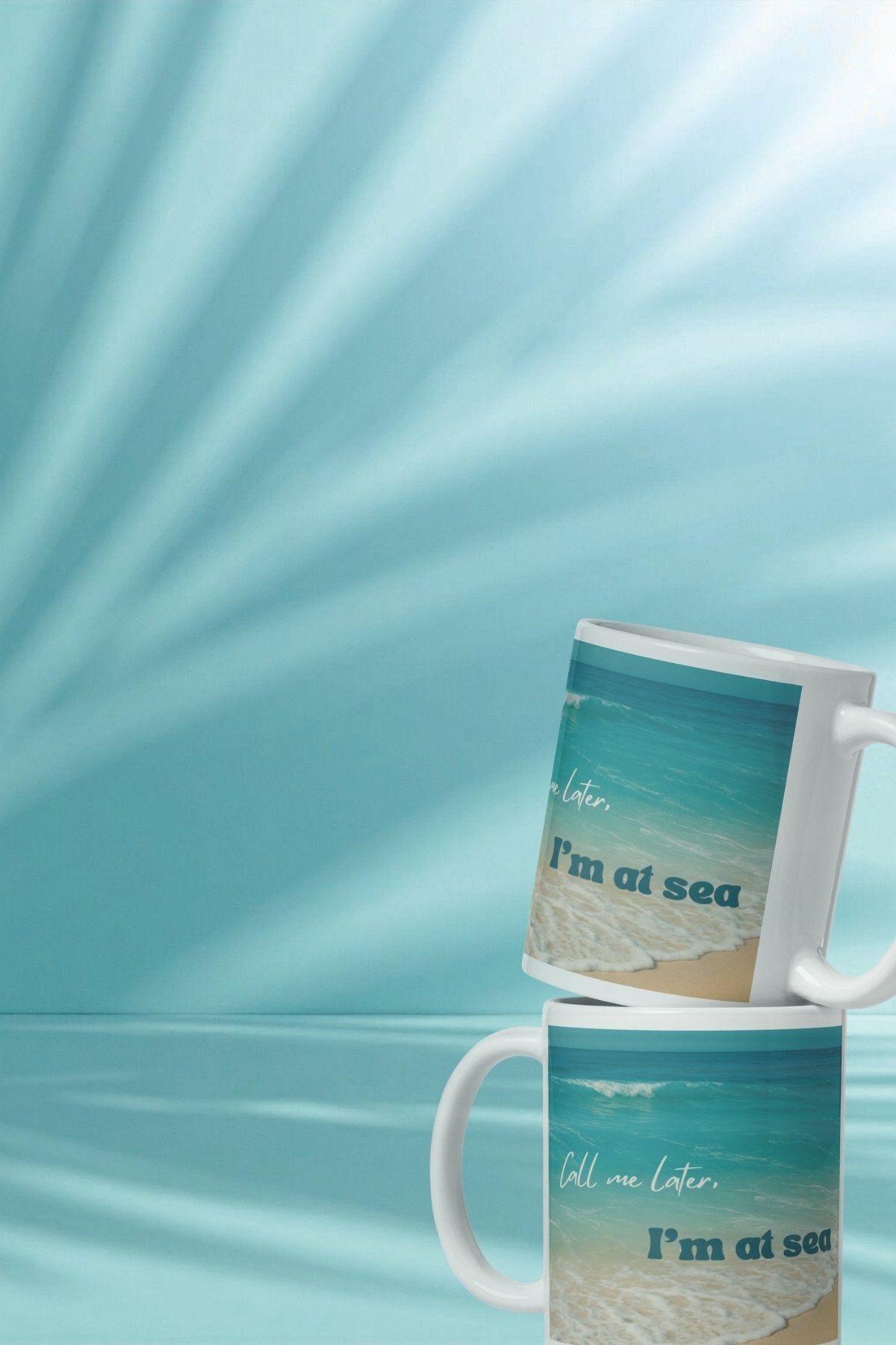 Two mugs with a beach design and text on a blue background.