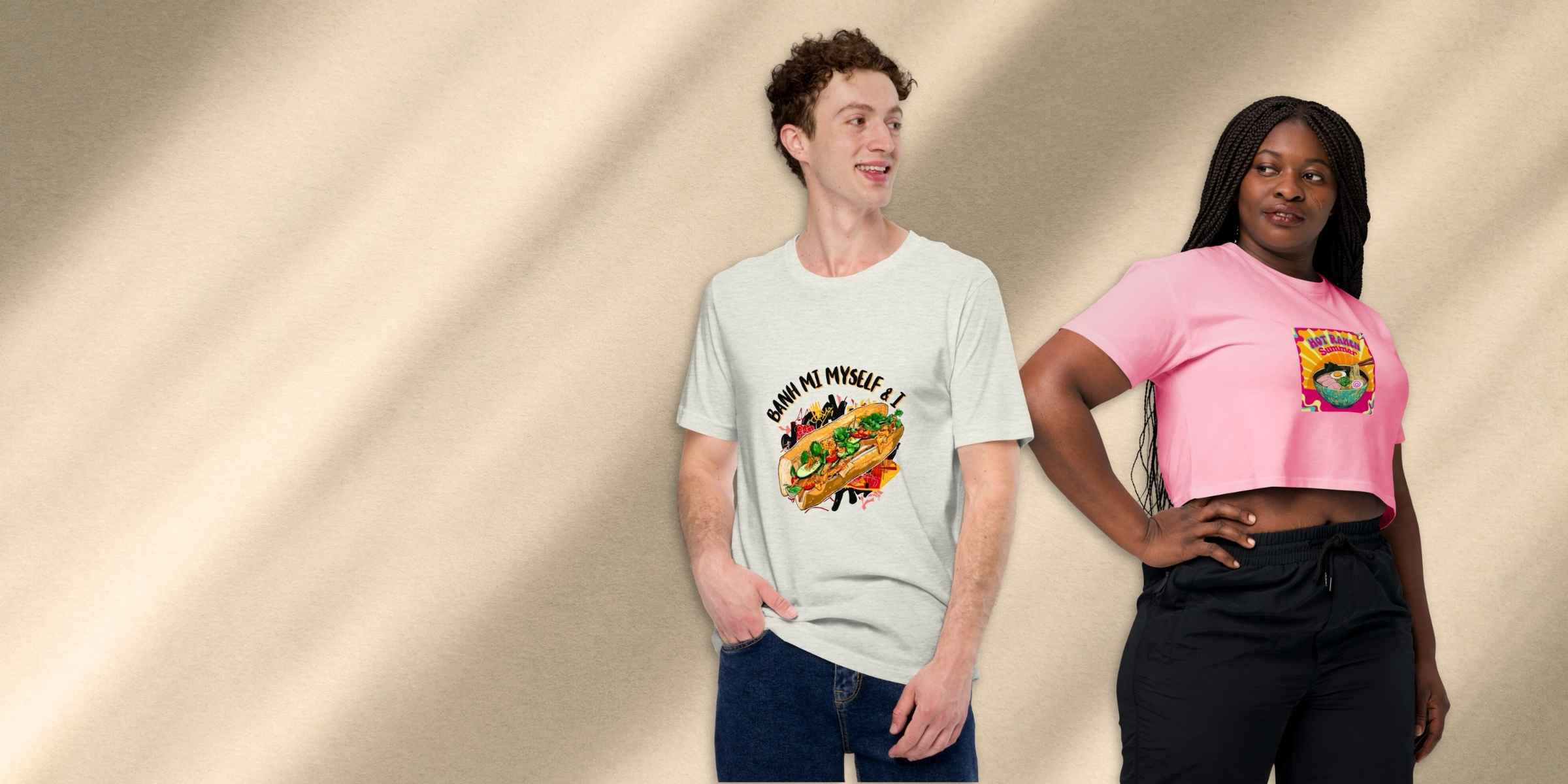 Two people wearing t-shirts with graphic  food pun designs on a beige background