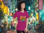Person wearing a pink t-shirt with a colorful Hot Ramen Summer retro pop art ramen t-shirt in an urban street setting