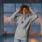 Person wearing a gray hoodie with a colorful graphic  of cute mochis on a cityscape background