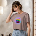 Woman wearing a brown t-shirt with a colorful graphic design of cute japanese mochis indoors.