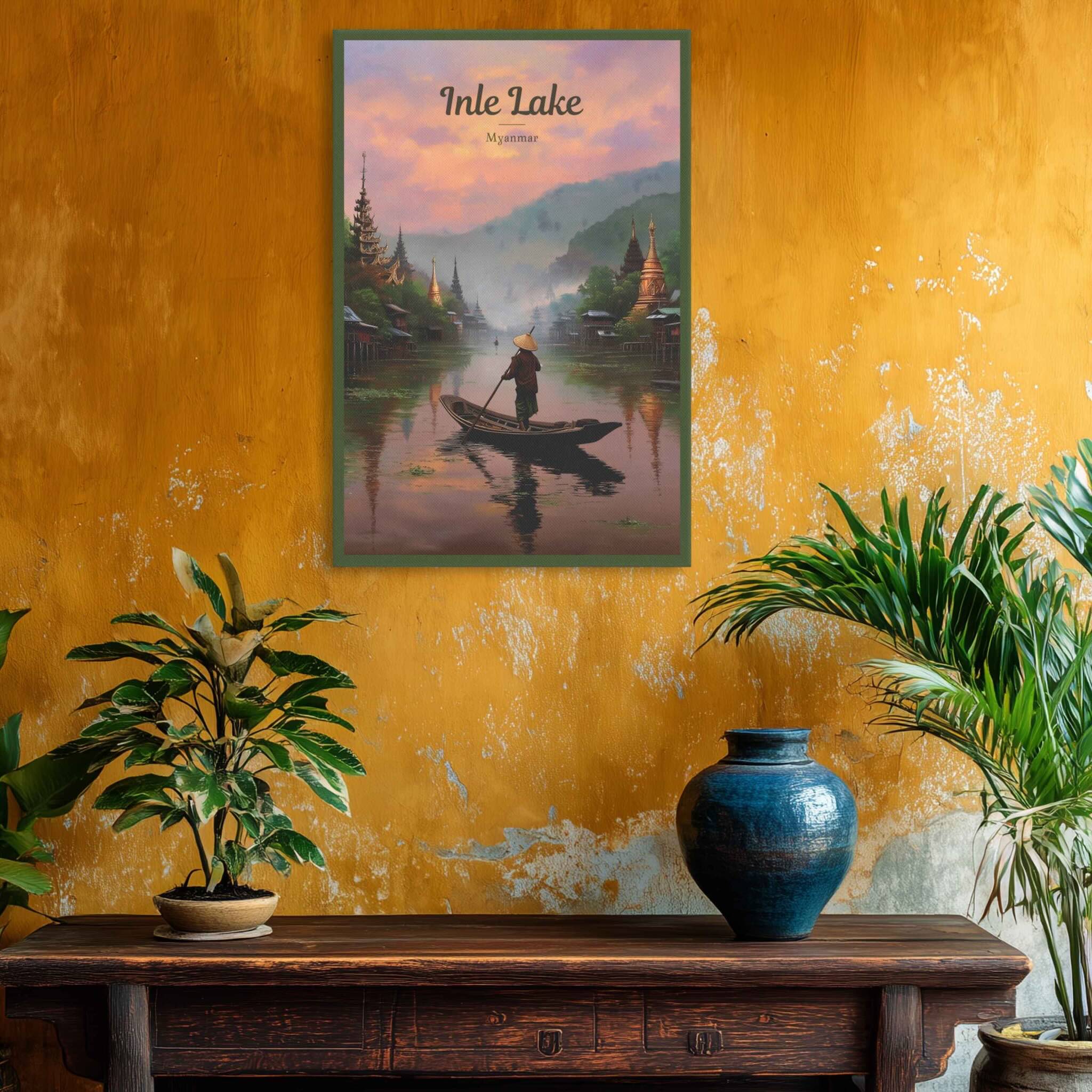 Framed artwork of Inle Lake on a textured yellow wall with plants and a vase below.