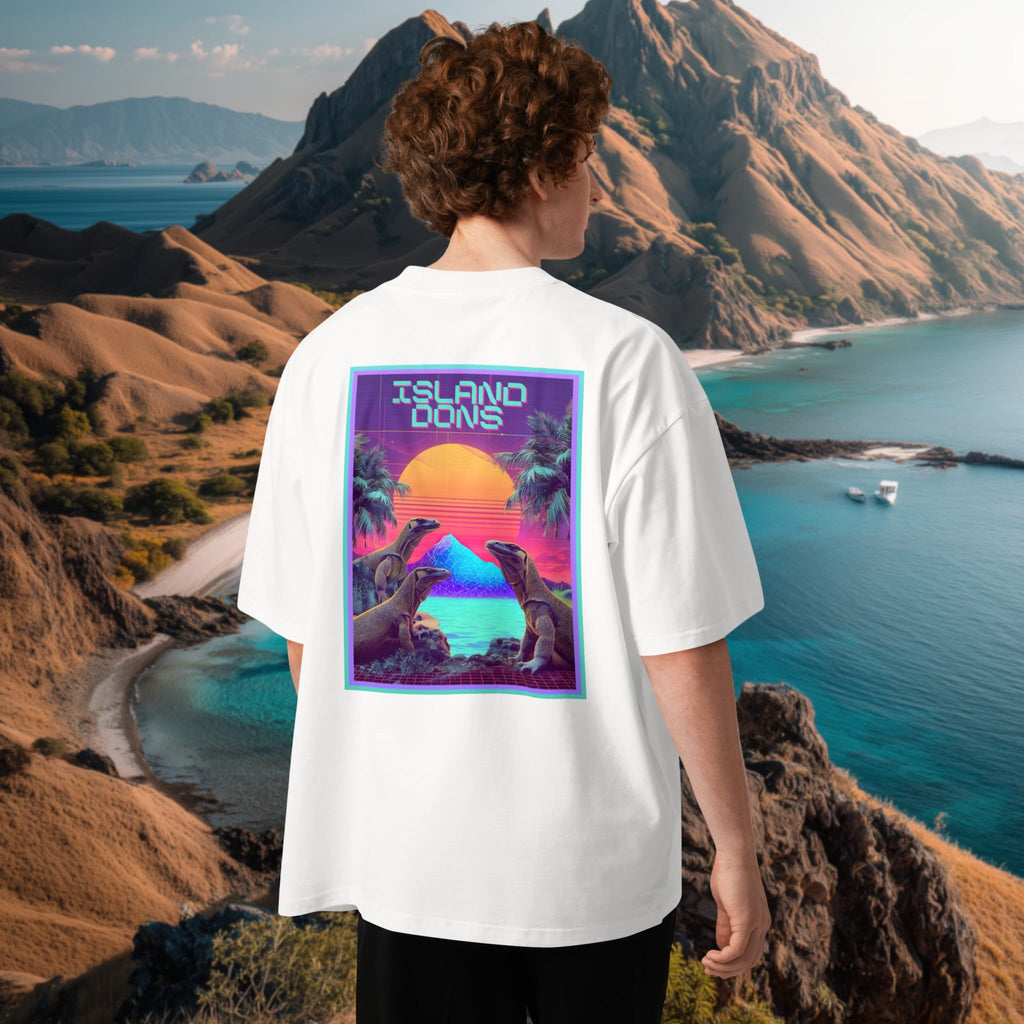 Male model wearing a white high neck t-shirt with a colorful graphic design of 'island dons' with retro 802 komodo dragons graphic in front of a scenic mountain and ocean view at Komodo Island, Indonesia.
