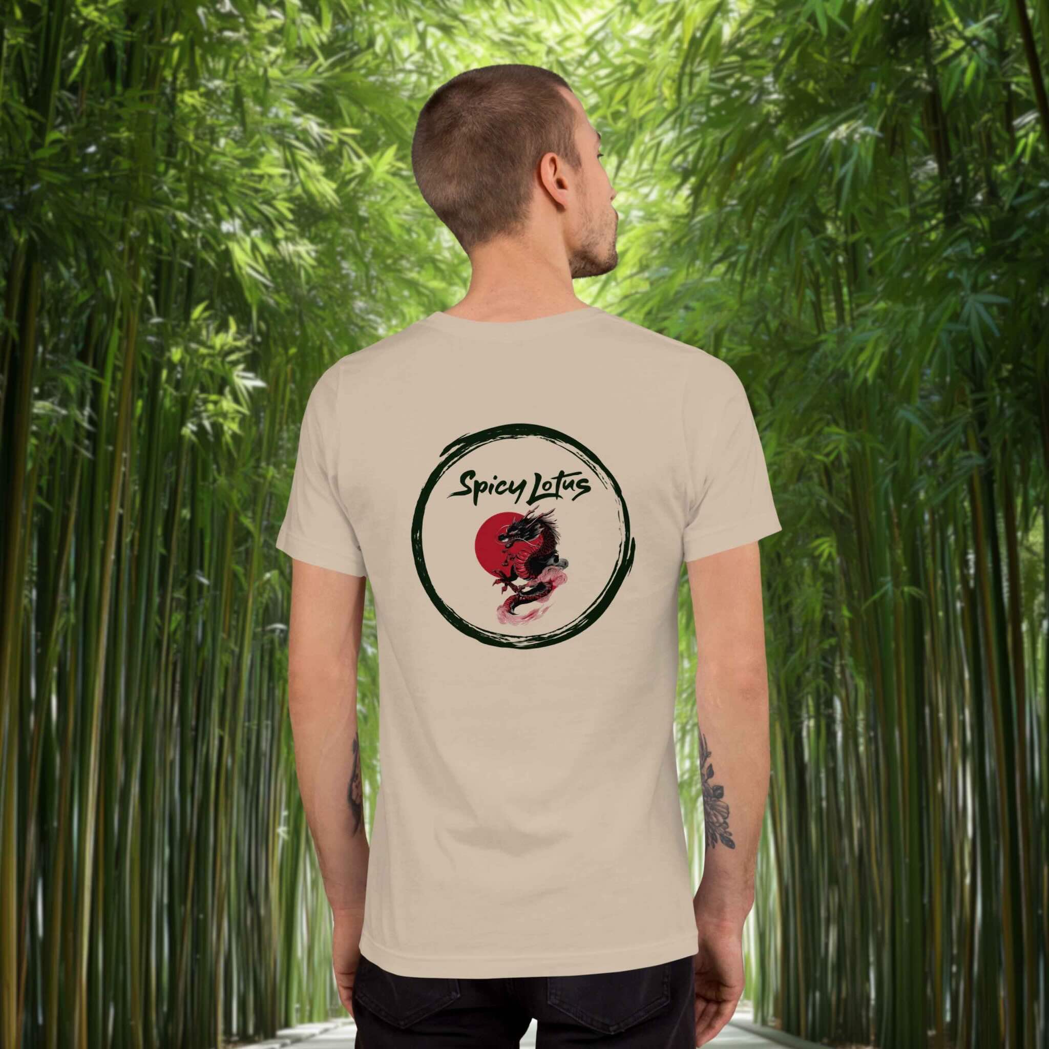 Man wearing a soft cream Spicy Lotus Dragon Enso back print T-shirt standing in front of bamboo forest lane