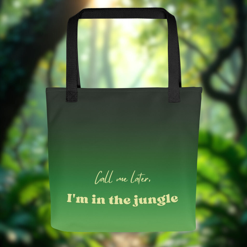 Green tote bag with text 'Call me later, I'm in the jungle' against a blurred forest background