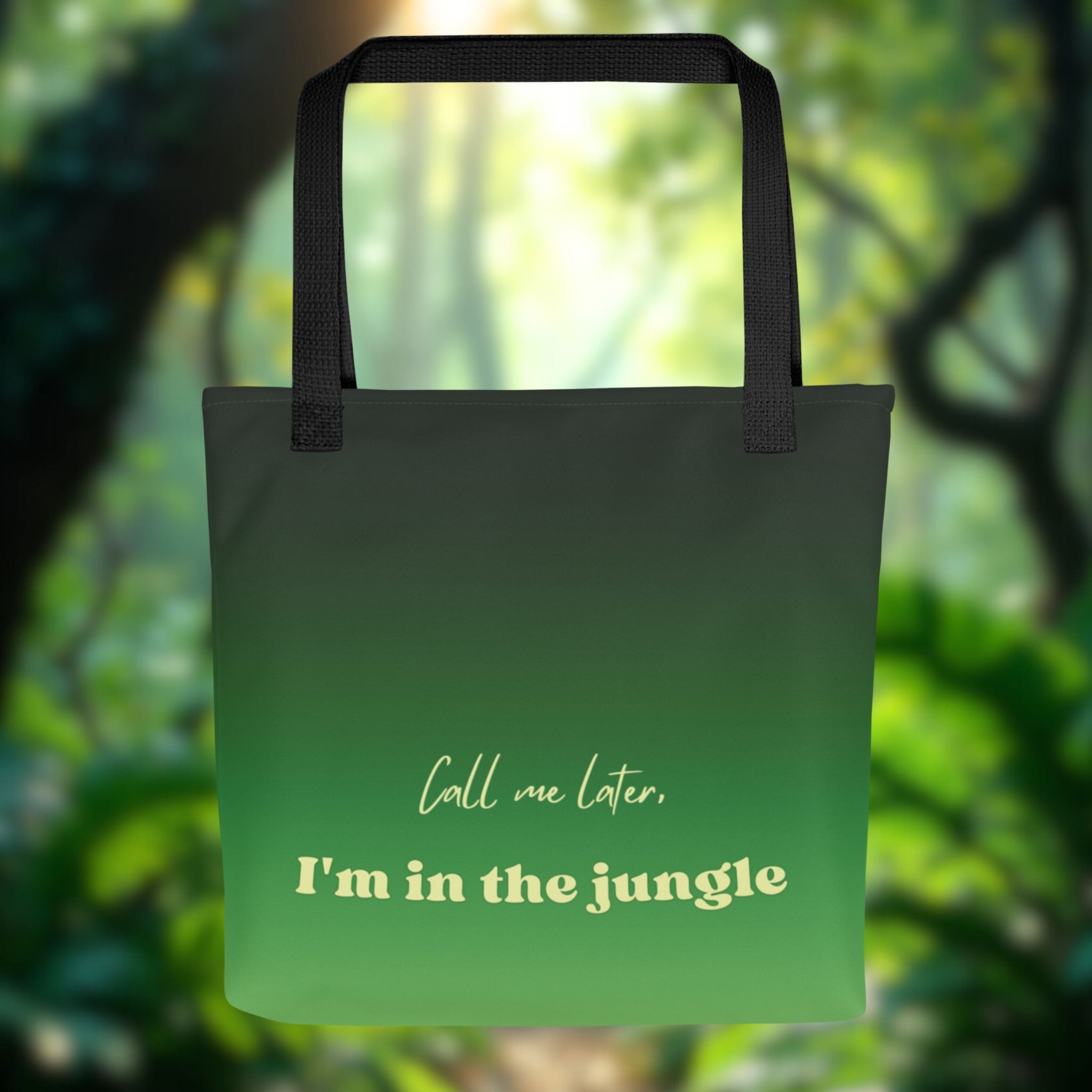Green tote bag with text 'Call me later, I'm in the jungle' against a blurred forest background