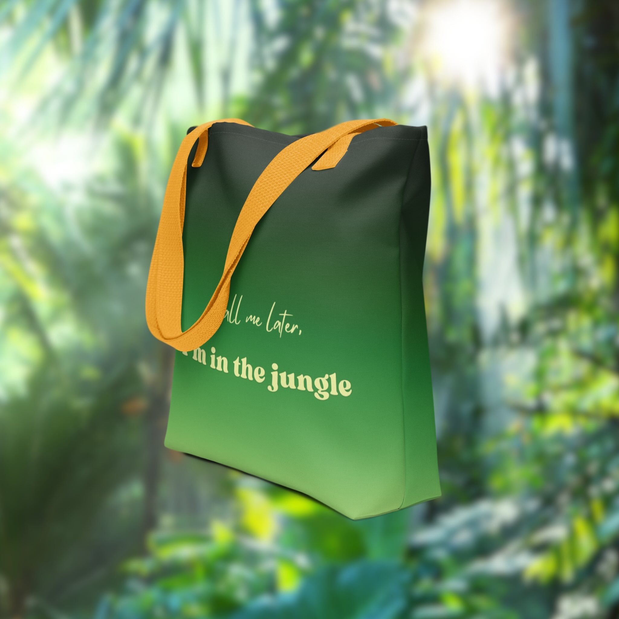 Green tote bag with yellow handle in a jungle setting