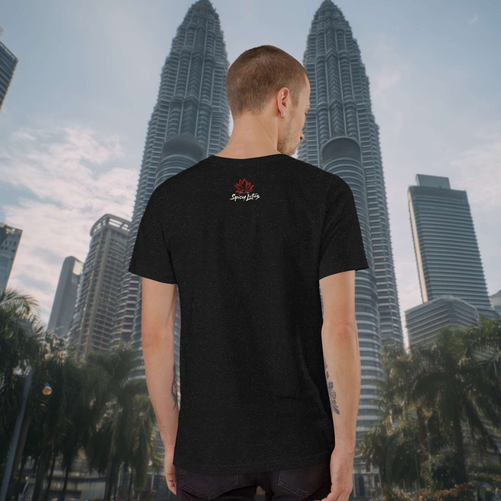 Person wearing a black t-shirt with a logo in front of the Petronas Twin Towers.