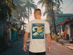 Man walking on a street with palm trees wearing a t-shirt with a 'Spicy Lotus Surf Club' design.