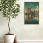 Framed artwork of Marina Bay Sands with a potted plant and vase on a light-colored wall.