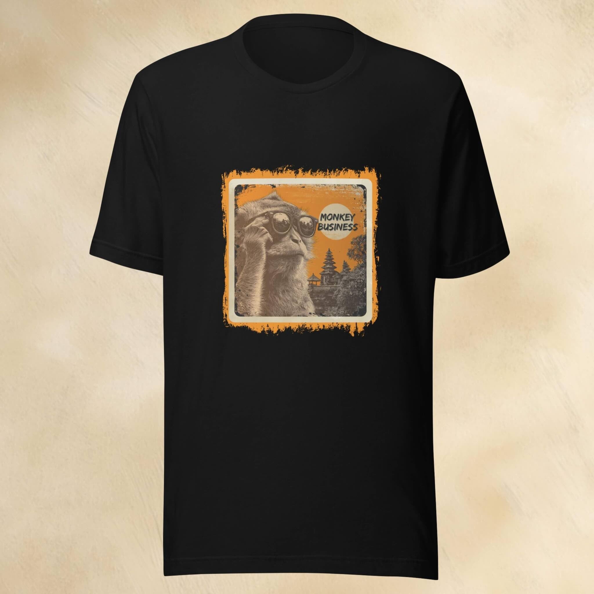 Black t-shirt with a graphic design of a cheeky monkey and text on a beige background