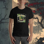 Person wearing a black t-shirt with a graphic design in front of a decorative wall.