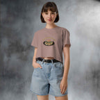 Person wearing a beige t-shirt with a graphic design  of japanese pancake and denim shorts in a studio setting